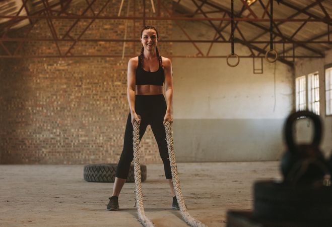 Female athlete about to start battling rope workout