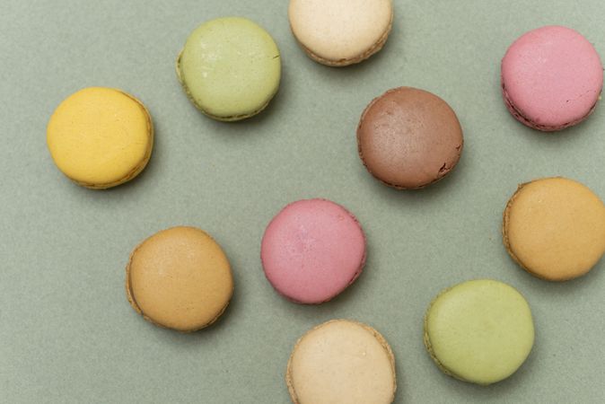 Top view of French pastel macaroons on a green table