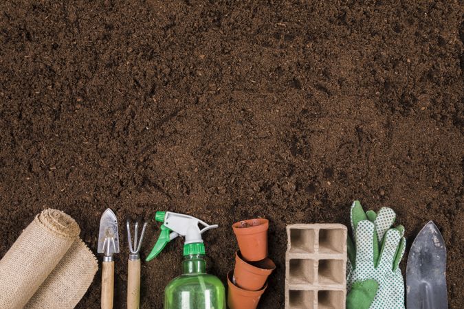 Gardening tools on soil flat lay