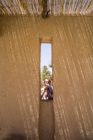 man behind stone wall