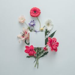 Creative layout made of various flowers with ligh paper card