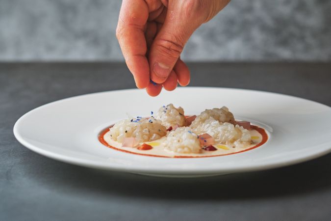 Delicious squid carpaccio with elegant squid ink grating