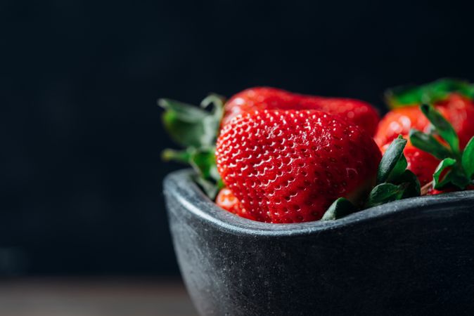 Fresh ripe strawberries in concrete bowl