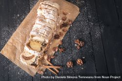 Top view of dessert bread with poppy seeds and walnuts on rustic table 0yA870