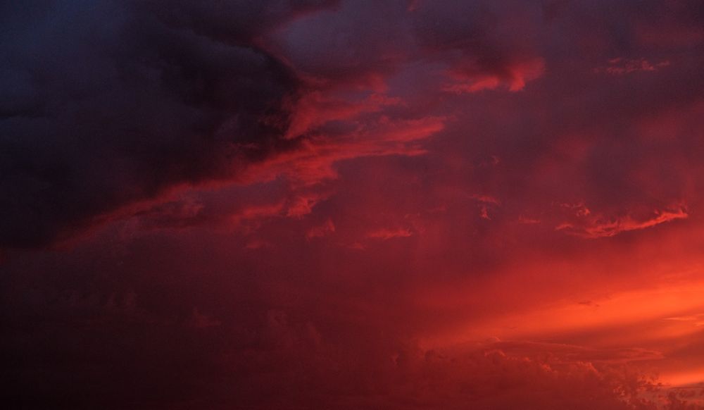 Bright red clouds in a colorful morning sky