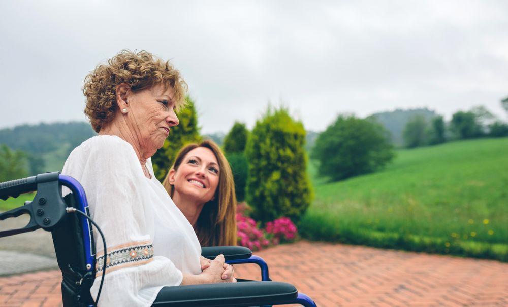 Older dissatisfied woman in a wheelchair with her daughter