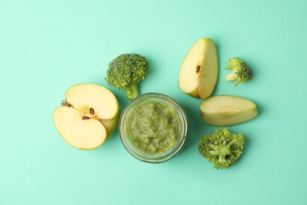 Vegetable puree on mint background, top view