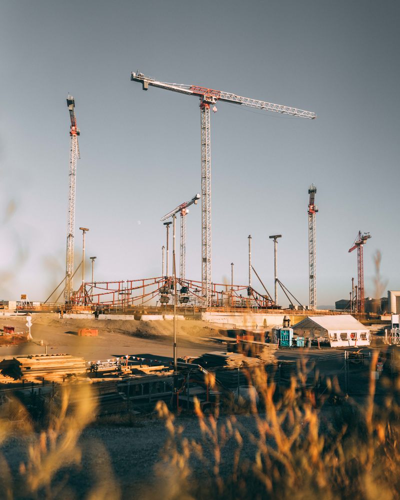 Low angle photo of tower cranes