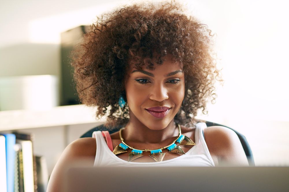 Black female entrepeuneaur working from her home office