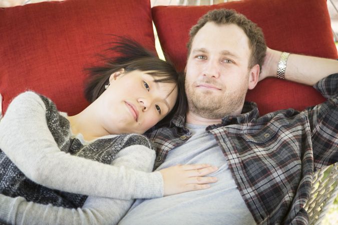 Interracial Couple Relaxing in a Hammock