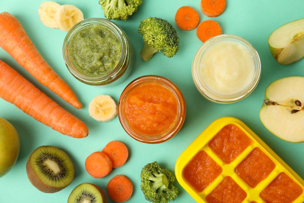 Composition with baby food on mint background, top view