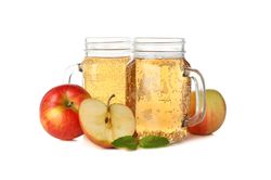 Apples and glass jars with cider isolated on blank background