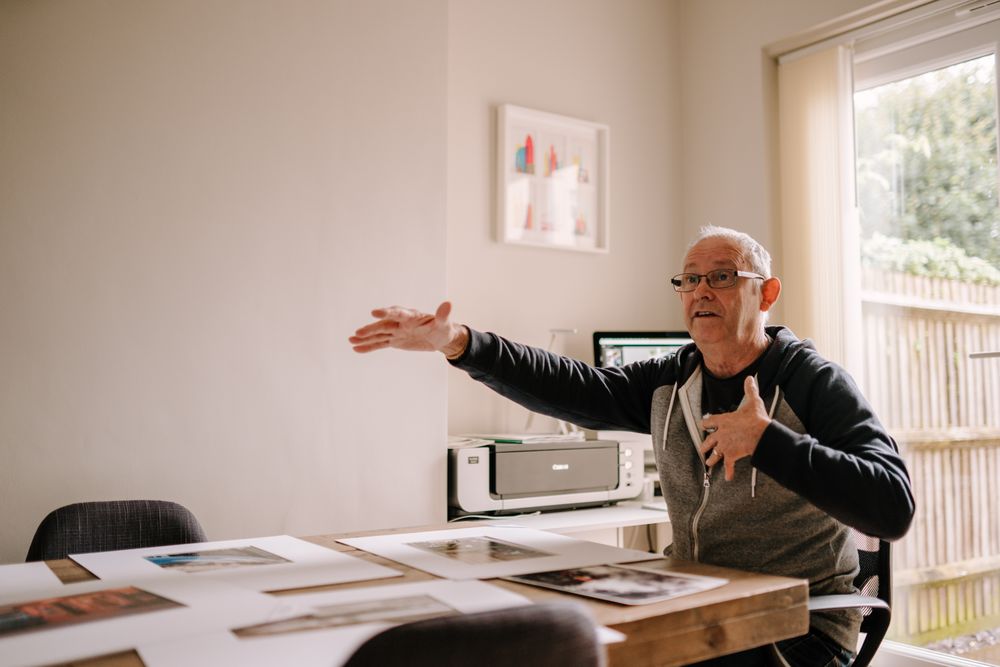 Man explaining something in his home office