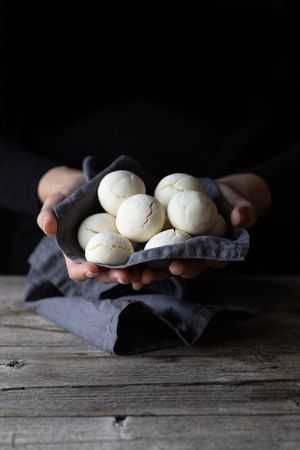 Unrecognizable woman showing handful of cornstarch cookies