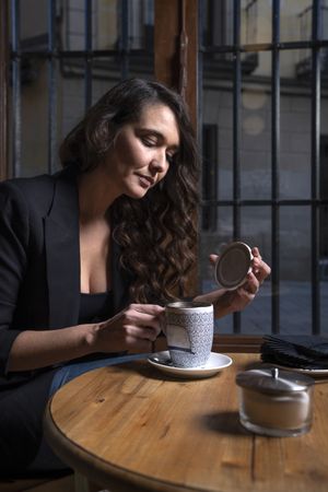 Young female with tea cup in cafe