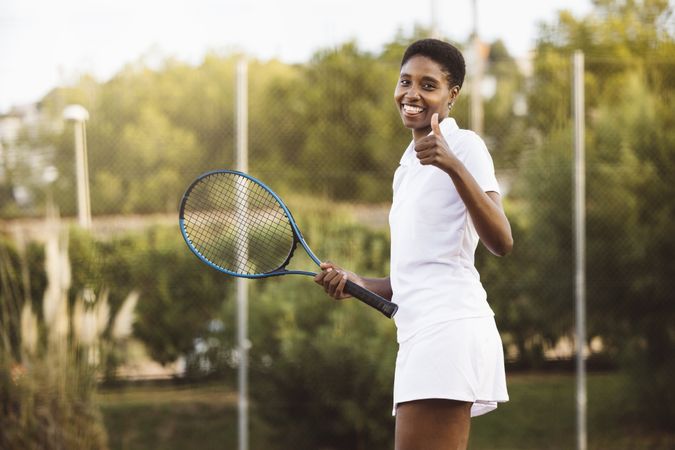 Young woman playing tennis match