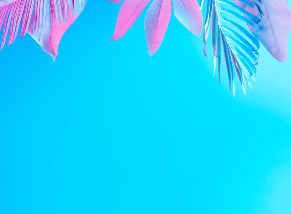 Tropical and palm leaves in vibrant bold blue and pink gradient holographic neon colors