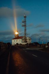 Road and lighthouse in evening