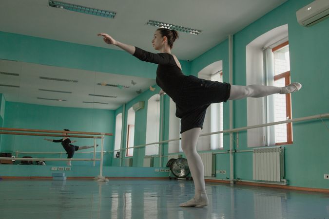 Woman dancing ballet in dance studio for practicing