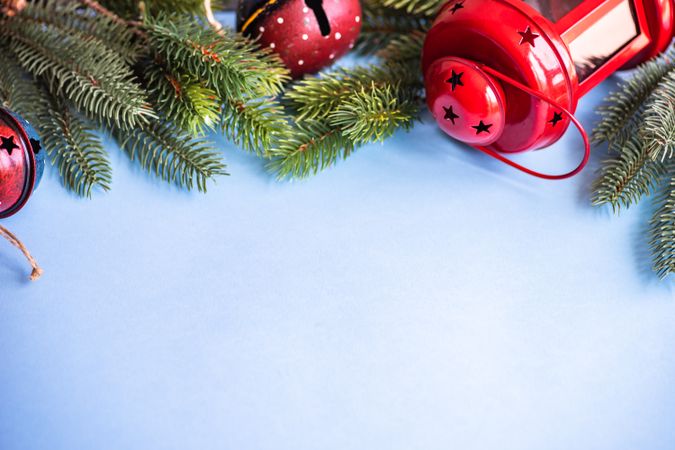 Christmas festive concept of red lanterns and branch on blue background