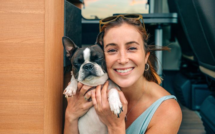 Happy woman posing to photo with cute dog