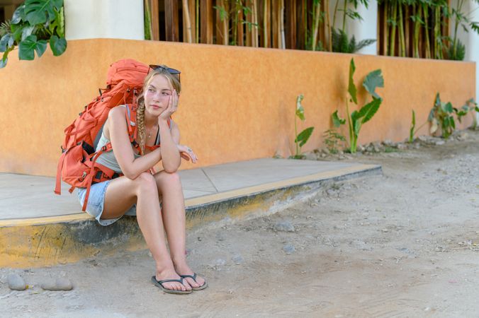 Young female traveler sitting and waiting for transport