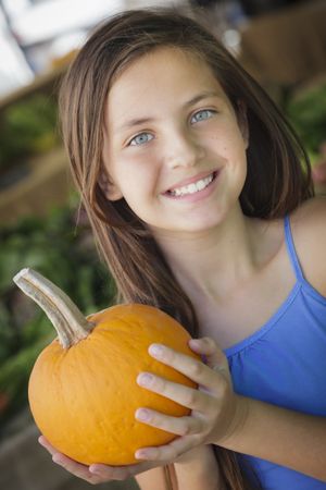 Girl Having Fun with the Pumpkins at Market