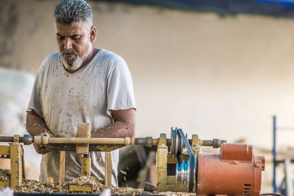 Man using woodworking machine at workplace