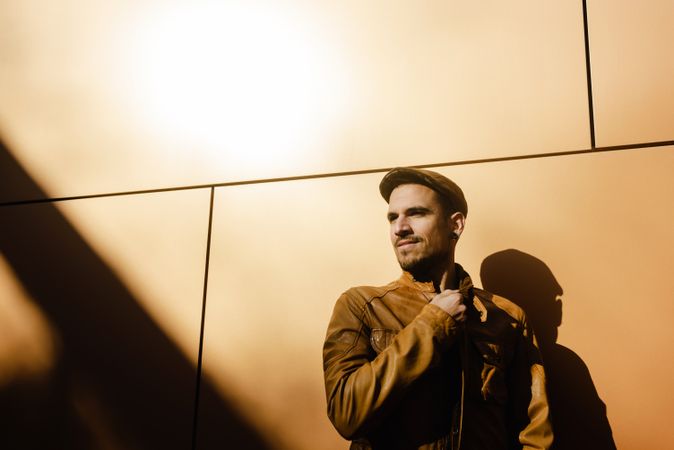 Confident guy leaning on wall