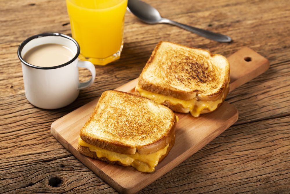 Grilled ham and cheese. Sandwich with cheese and ham on grill.