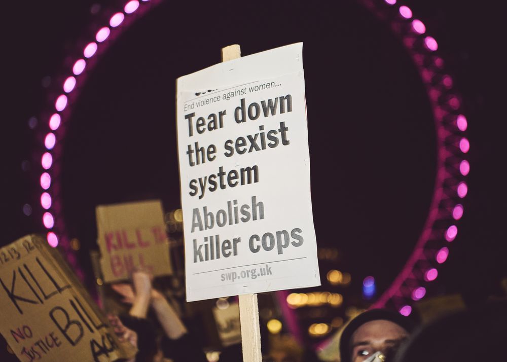 London, England, United Kingdom - March 16, 2021: Protest sign framed by London Eye