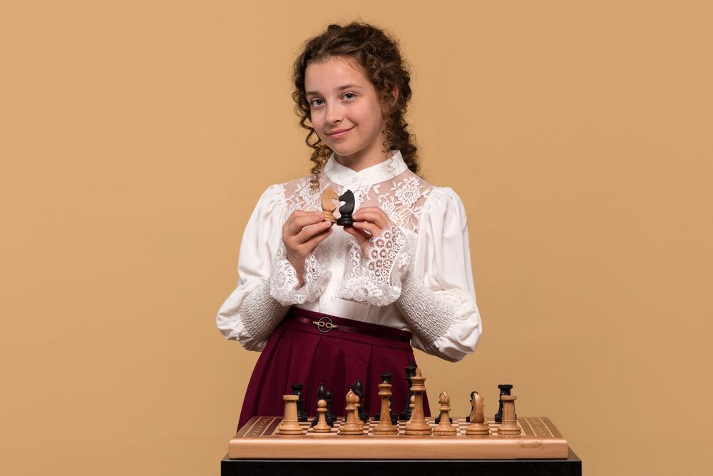 Young girl displaying  chess knights