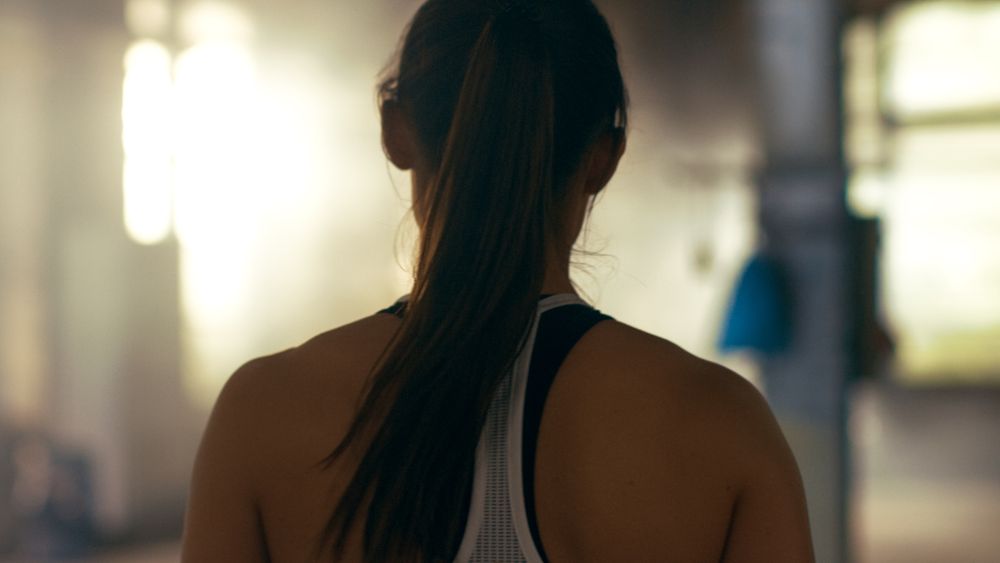 Shot from the back of Athletic Woman Entering Gym.