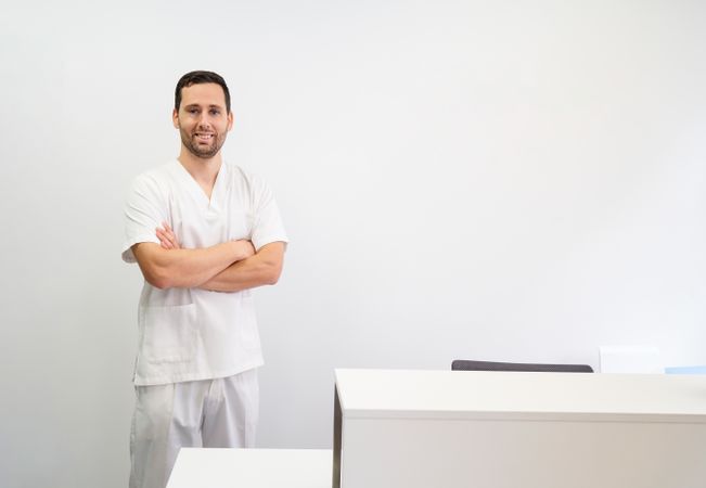 portrait of a male physiotherapist in his clinic looking at the