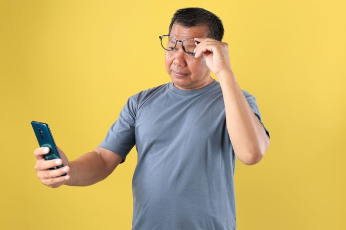 Mature Asian Man with Presbyopia