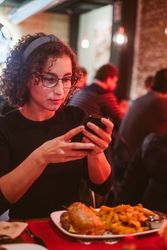 Young woman taking photo of food