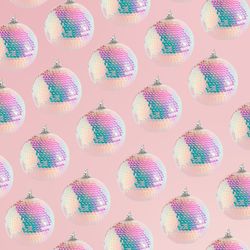 Sparkly disco Christmas bauble ornaments on a soft pink background