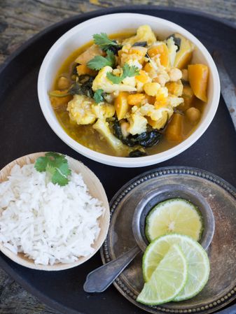Plate with vegetarian curry on tray