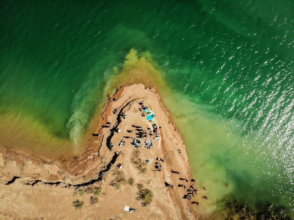 Aerial view of people on brown sand beach