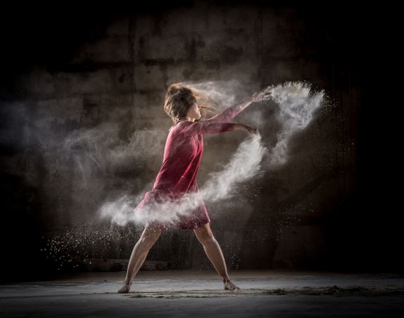 Young woman between fog in darkness