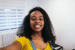 Smiling Selfie: Young Black Woman in Yellow Shirt