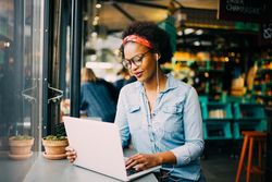 Woman on laptop in cafe