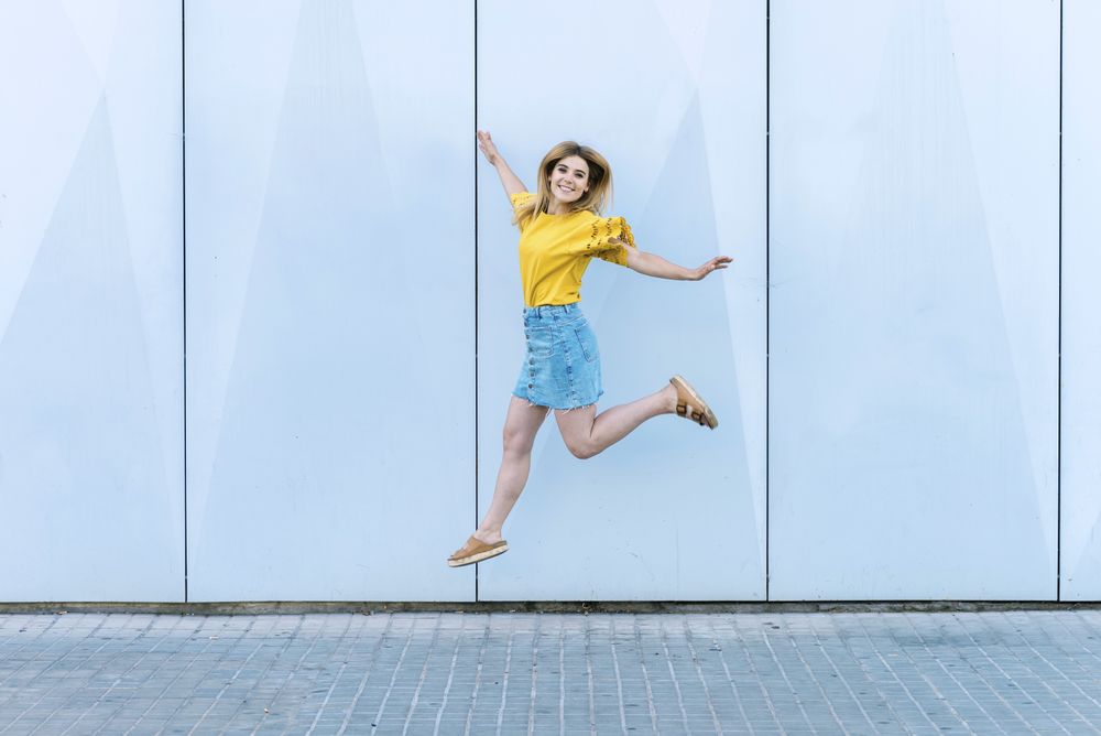 Young cheerful woman jumping