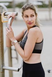 Sportswoman resting after workout in a sandy beach