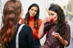 Women sipping coffee with her friends