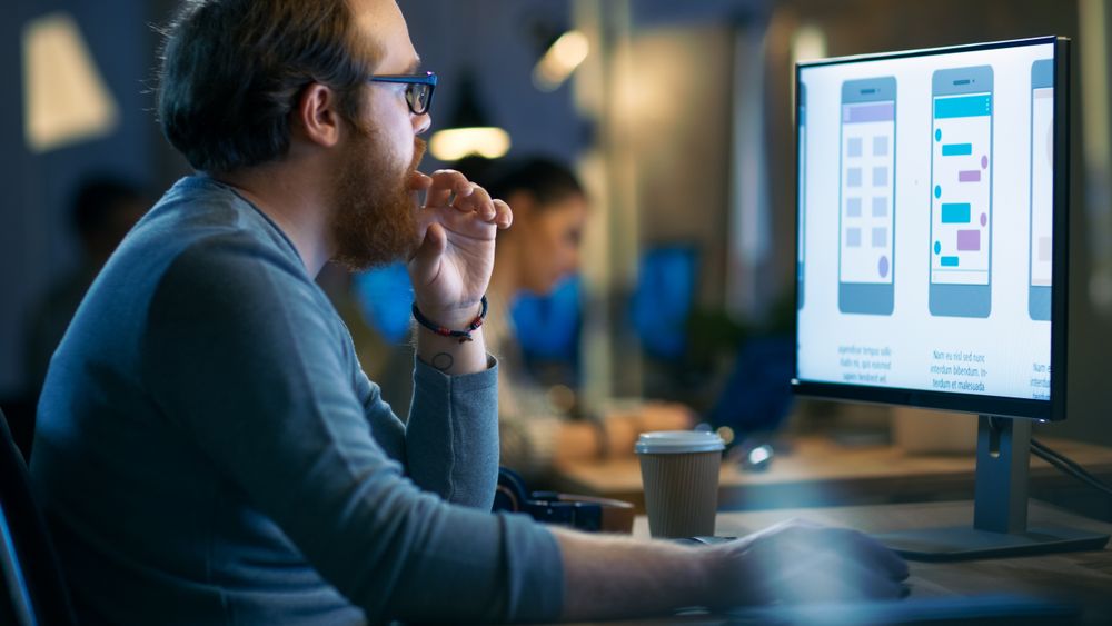 Professional Statistician Works with Graphics on His Personal Computer.