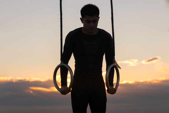 Sportsman training on gymnastic rings