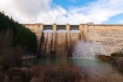 Concrete hydroelectric power station in sunlight