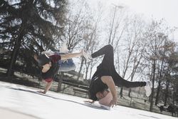 Young men dancing break dance in park