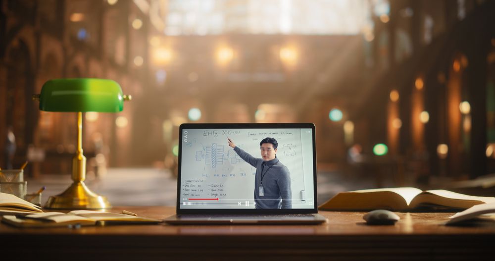 Asian Male Presenting Business Strategy on a Laptop Screen